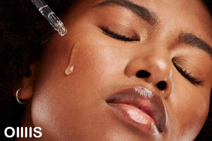 oillis "Exosome Serum: The Ultimate Guide black lading using Exosome serum on her skin gently