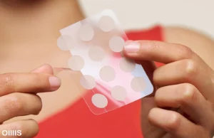 pimple patches that little paper tha oillis promote it can treat wart on your body that a lady hold on her hands in front of camera