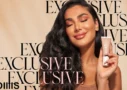 huda beauty GloWish Review a picture of Huda kattan that well known as HudaBeauty holding her new trend product on her handand smiling