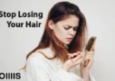 an image of a young women warring about losing her hair and looking at hair comb