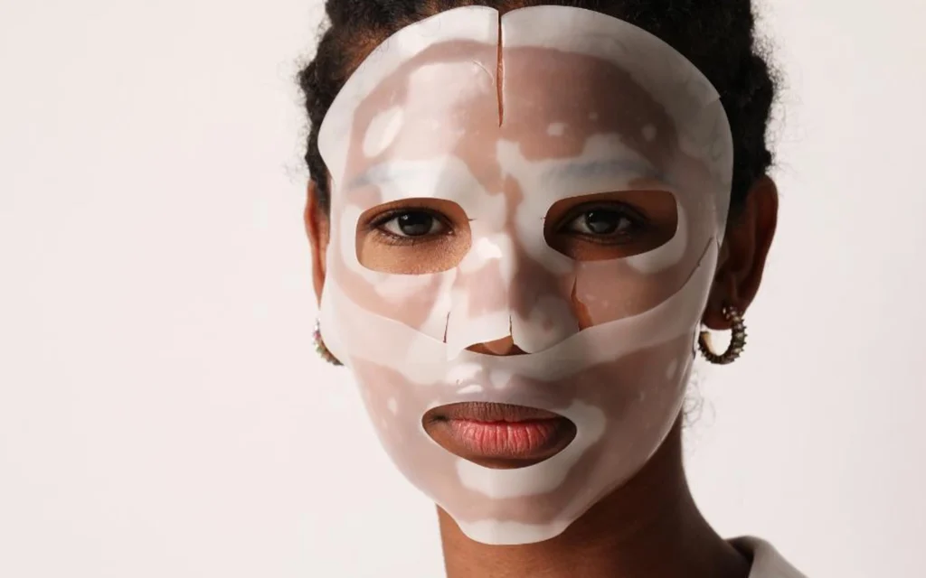 a black lady wearing BIODANCE skincare bio collagen face mask with white background