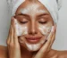 how to get clear skin just like the younger age a woman using cleaning products to clean and clear her skin like foam cleaner